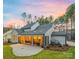 Scenic backyard featuring a covered patio, outdoor furniture, and well-manicured landscaping at 3288 Sherman Dr, Lancaster, SC 29720
