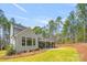 Large backyard featuring a covered patio, lush lawn, and mature trees for privacy at 3288 Sherman Dr, Lancaster, SC 29720