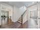 Hallway with hardwood floors, and stairs leading to an open-concept kitchen and dining area at 3288 Sherman Dr, Lancaster, SC 29720