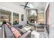 Covered patio with a stone fireplace, ceiling fan, and comfortable seating, perfect for outdoor relaxation at 3288 Sherman Dr, Lancaster, SC 29720