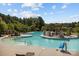 A large, resort-style swimming pool with a central island, lounge chairs, and shaded seating areas at 3288 Sherman Dr, Lancaster, SC 29720