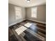 Bedroom featuring luxury vinyl plank flooring, neutral colors, and updated windows at 32884 Old Salisbury Rd, Albemarle, NC 28001