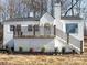 Charming white brick home featuring a cozy front porch, decorative windows and manicured landscaping at 32884 Old Salisbury Rd, Albemarle, NC 28001