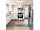 A bright kitchen with new stainless steel appliances, butcher block counters, and white cabinets at 32884 Old Salisbury Rd, Albemarle, NC 28001