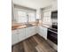 Well-lit kitchen featuring butcher block countertops, white cabinets and stainless steel microwave and range at 32884 Old Salisbury Rd, Albemarle, NC 28001