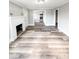 Spacious, sunny living room featuring a fireplace, new floors, and an open floor plan at 32884 Old Salisbury Rd, Albemarle, NC 28001
