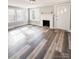 Cozy living room features new floors, a decorative fireplace and bright windows at 32884 Old Salisbury Rd, Albemarle, NC 28001