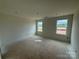 Unfinished bedroom featuring two windows, bare walls, and concrete floor at 338 Knotty Wood Dr # 69, Monroe, NC 28110