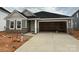 Charming single-story home features a stone facade, gray siding, and an attached two-car garage at 338 Knotty Wood Dr # 69, Monroe, NC 28110