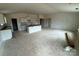 Spacious unfinished living room and kitchen with a vaulted ceiling and white cabinets at 338 Knotty Wood Dr # 69, Monroe, NC 28110