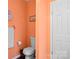 Cozy bathroom featuring a toilet, towel rack, and peach-colored walls, offering a comfortable and functional space at 390 Rocky Rick Rd, Rockwell, NC 28138