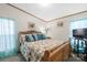 Comfortable bedroom with a floral quilt, wood frame bed, and curtains, creating a cozy and relaxing space at 390 Rocky Rick Rd, Rockwell, NC 28138
