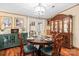 Dining room features a wooden dining table, seating for four, elegant light fixture and french doors at 390 Rocky Rick Rd, Rockwell, NC 28138