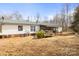 View of the home with a green metal roof and covered porch at 390 Rocky Rick Rd, Rockwell, NC 28138