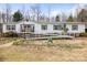 Single-story home with a long ramp, showcasing accessibility and a welcoming facade at 390 Rocky Rick Rd, Rockwell, NC 28138