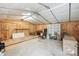 Spacious garage interior with wooden accents, shelving, and storage at 390 Rocky Rick Rd, Rockwell, NC 28138