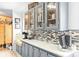 Kitchen features gray cabinets, white countertops, a decorative backsplash, and lots of storage space at 390 Rocky Rick Rd, Rockwell, NC 28138