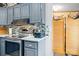Well-equipped kitchen with gray cabinets, stainless steel appliances, and modern countertops at 390 Rocky Rick Rd, Rockwell, NC 28138