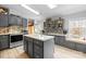 Charming kitchen with gray cabinets, modern appliances, a kitchen island, and views to the dining room at 390 Rocky Rick Rd, Rockwell, NC 28138