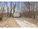 View of the shed, nestled among trees at 390 Rocky Rick Rd, Rockwell, NC 28138