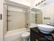 Bathroom with a vessel sink, soaking tub, and tiled walls at 521 N Graham St # 2B, Charlotte, NC 28202