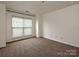 Empty bedroom with neutral carpet, a large window, and ample natural light at 521 N Graham St # 2B, Charlotte, NC 28202