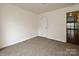 Vacant bedroom featuring neutral carpet, a window, and a closet at 521 N Graham St # 2B, Charlotte, NC 28202