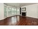 Spacious living room with hardwood flooring, fireplace, and large windows offering natural light at 521 N Graham St # 2B, Charlotte, NC 28202