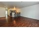 Bright living area with hardwood floors open to the kitchen with barstool seating at 521 N Graham St # 2B, Charlotte, NC 28202