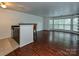 Open living space with hardwood floors, bar area, and bright bay windows at 521 N Graham St # 2B, Charlotte, NC 28202