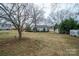 View of the backyard with storage shed, and chain link fence at 816 S Point Rd, Belmont, NC 28012