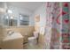 Traditional bathroom with a patterned shower curtain and tiled walls at 816 S Point Rd, Belmont, NC 28012