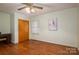 Comfortable bedroom with hardwood floors, ceiling fan, window with blinds, and closet storage at 816 S Point Rd, Belmont, NC 28012