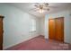 Carpeted bedroom with a window, closet, and ceiling fan offers a cozy space to relax and unwind at 816 S Point Rd, Belmont, NC 28012