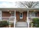 Cozy covered front porch with brick facade, white railing, and comfortable seating at 816 S Point Rd, Belmont, NC 28012