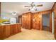 Spacious kitchen with wood paneling, retro yellow countertops, and vintage ceiling fans for a classic feel at 816 S Point Rd, Belmont, NC 28012