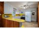 Bright kitchen with vintage white cabinetry and yellow accents at 816 S Point Rd, Belmont, NC 28012