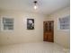 Bright living room with neutral walls, tiled floors, two windows and vintage cabinet for storage and charm at 816 S Point Rd, Belmont, NC 28012