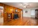 Charming living room with wood paneling, brick fireplace, and hardwood floors at 816 S Point Rd, Belmont, NC 28012
