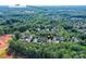 This aerial view shows a community with a tree canopy with I-77 shown in the background at 8925 Rosalyn Glen Rd, Cornelius, NC 28031