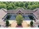 Stunning aerial view of a multi-unit property featuring a circular driveway and lush green landscaping at 8925 Rosalyn Glen Rd, Cornelius, NC 28031
