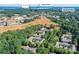 Aerial shot of a lakeside residential neighborhood featuring lush trees and close proximity to businesses and a lake at 8925 Rosalyn Glen Rd, Cornelius, NC 28031