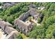 An aerial view showcases a unique courtyard design, nestled amongst lush green trees and manicured landscaping at 8925 Rosalyn Glen Rd, Cornelius, NC 28031