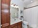 This bathroom has a wood vanity with framed mirror and a shower-tub combo at 8925 Rosalyn Glen Rd, Cornelius, NC 28031