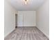 A spacious bedroom with an open door, neutral carpet, and white walls at 8925 Rosalyn Glen Rd, Cornelius, NC 28031