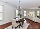 Cozy dining room with a dark wood table, chandelier, and natural light at 8925 Rosalyn Glen Rd, Cornelius, NC 28031