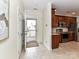 Welcoming entryway with tile flooring, a storm door, and a glimpse into the modern kitchen with stainless appliances at 8925 Rosalyn Glen Rd, Cornelius, NC 28031