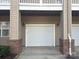 Attached one car garage featuring brick accents and convenient access at 8925 Rosalyn Glen Rd, Cornelius, NC 28031