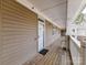 Hallway with exterior door and tan-colored siding of building and view of outdoor walkway at 8925 Rosalyn Glen Rd, Cornelius, NC 28031