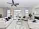 Bright living room with a ceiling fan, fireplace, and access to the outdoor patio at 8925 Rosalyn Glen Rd, Cornelius, NC 28031